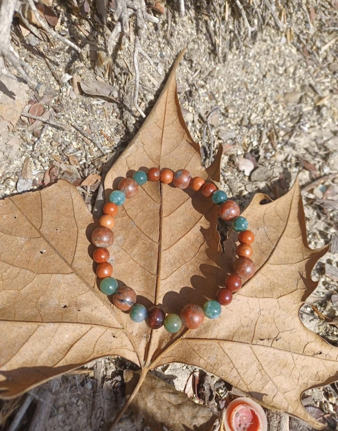 Beaded bracelet on a large leaf. 