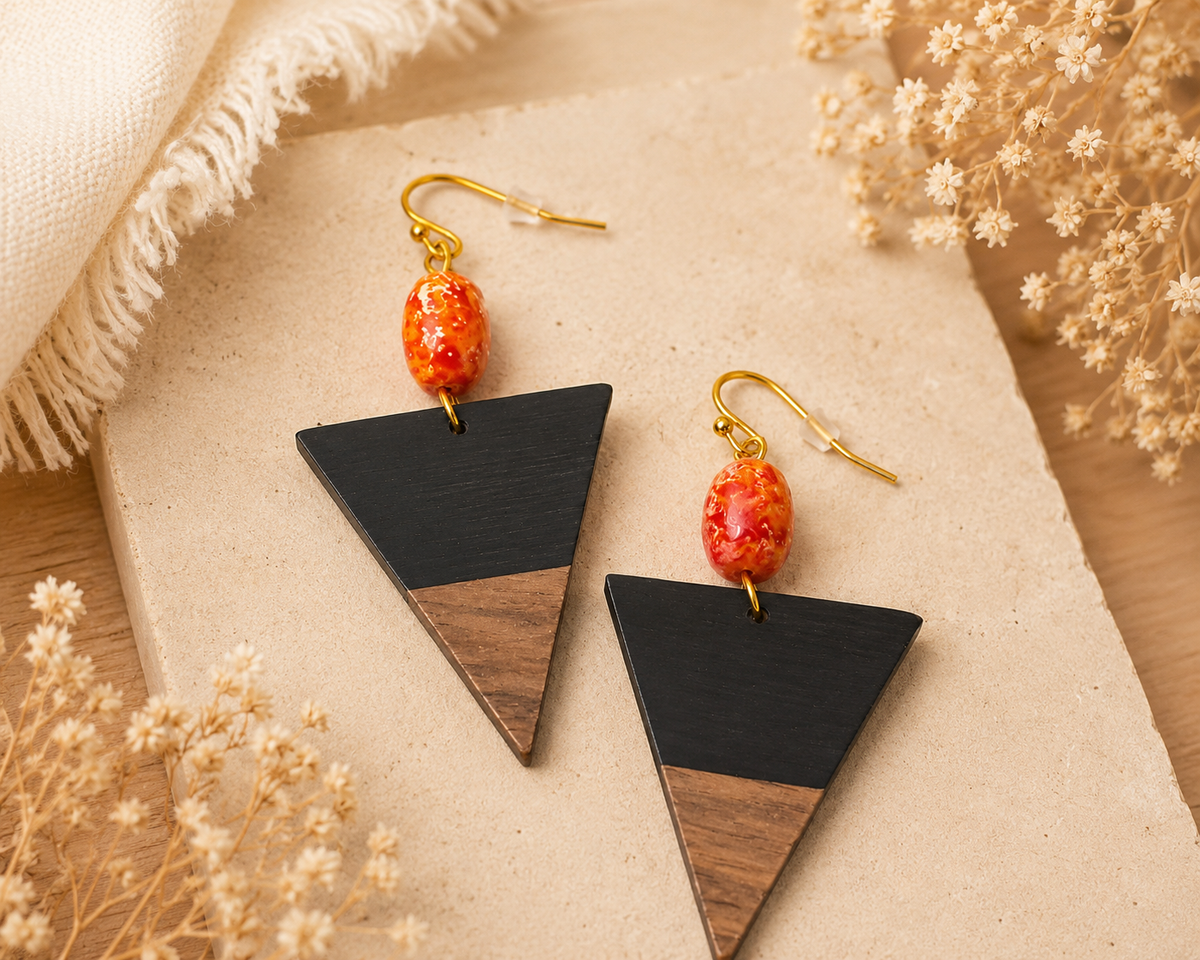 Red beaded earrings with leather textured details.